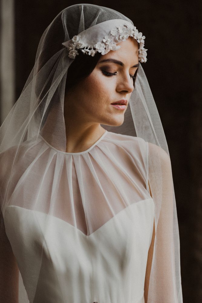 Abito da sposa con velo e copricapo floreale ispirato al passato